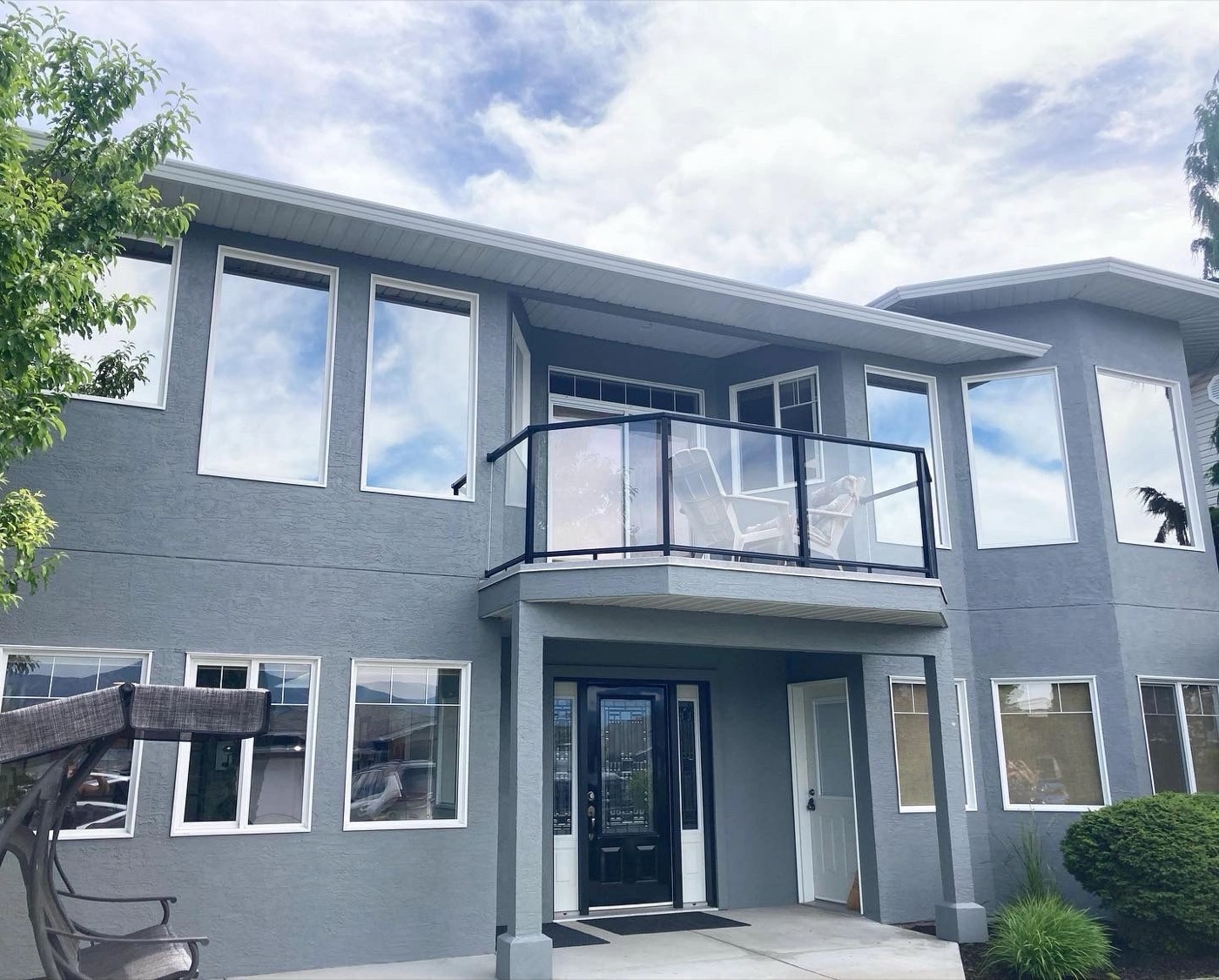 Two-storey home with freshly painted grey exterior and white trim