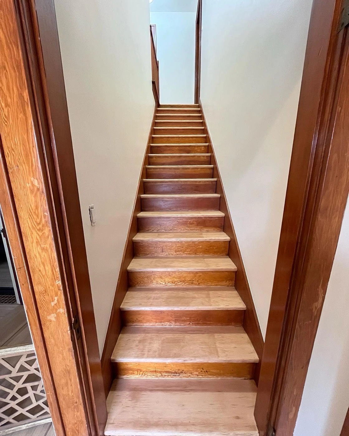 Interior staircase with stained wood treads and trim